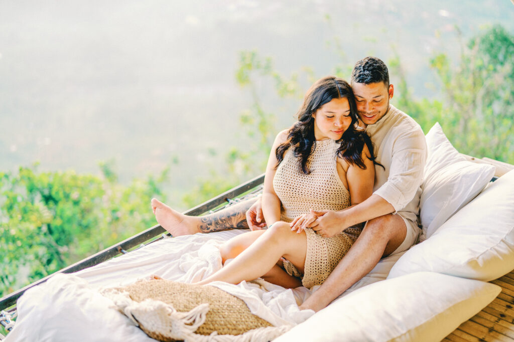 Couple standing on Laputa Villa balcony with Mount Agung sunrise view Bali