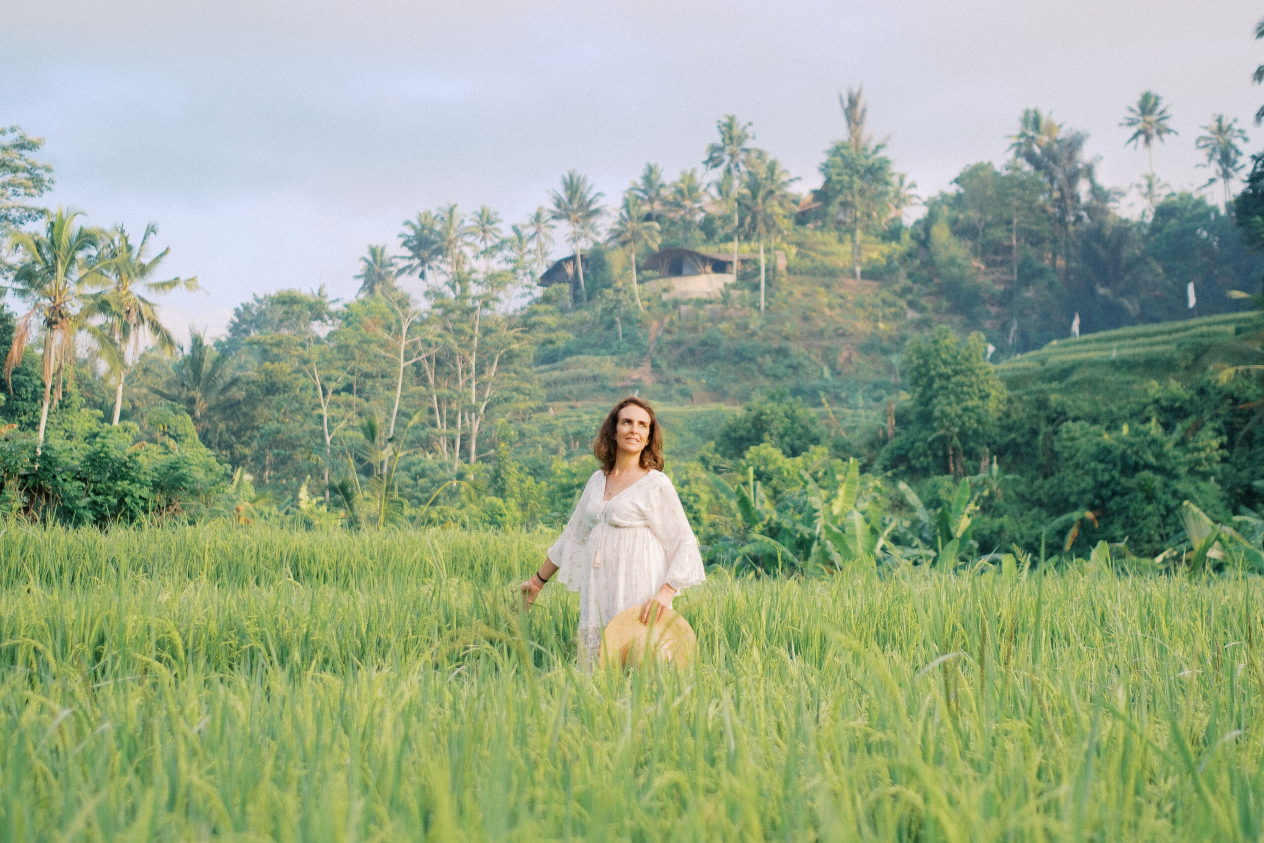 Middle-aged woman Laura solo photoshoot in ripening rice fields at Camaya Bali