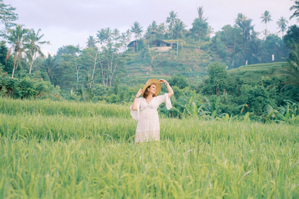 Middle-aged woman Laura solo photoshoot in ripening rice fields at Camaya Bali