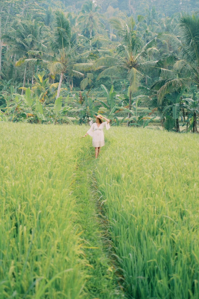Middle-aged woman Laura solo photoshoot in ripening rice fields at Camaya Bali
