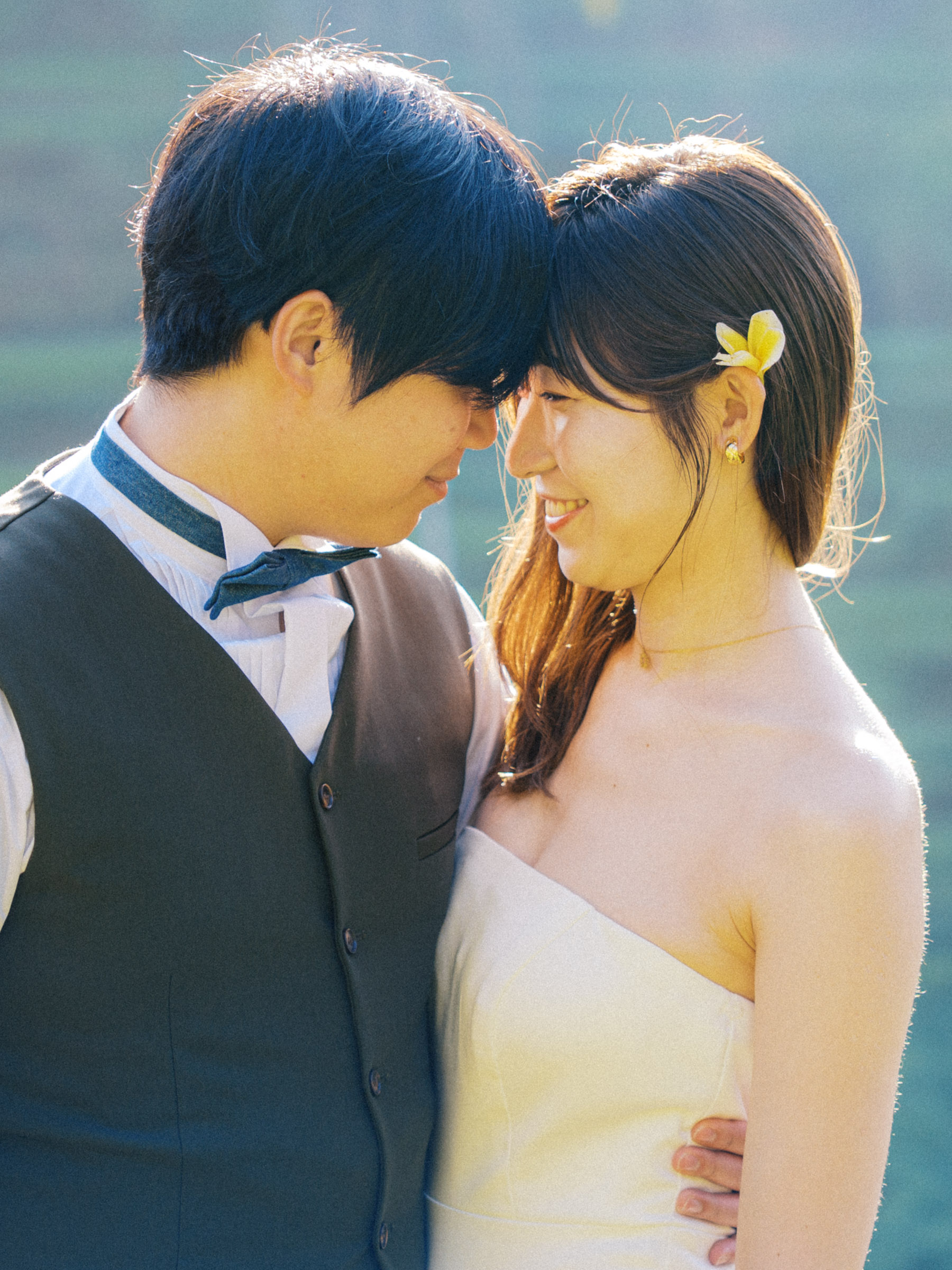 Close portrait of Tatsu and Mika touching foreheads in the morning light
